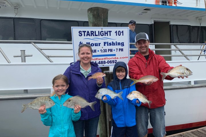 a person standing in front of a group of people posing for the camera
