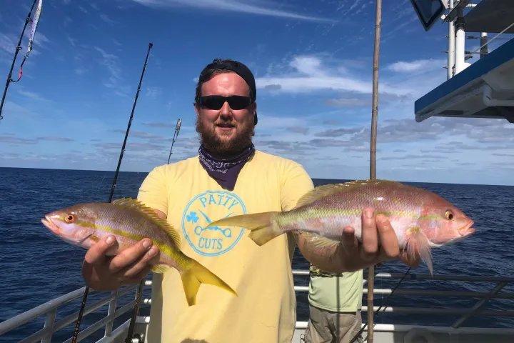 a man holding a fish