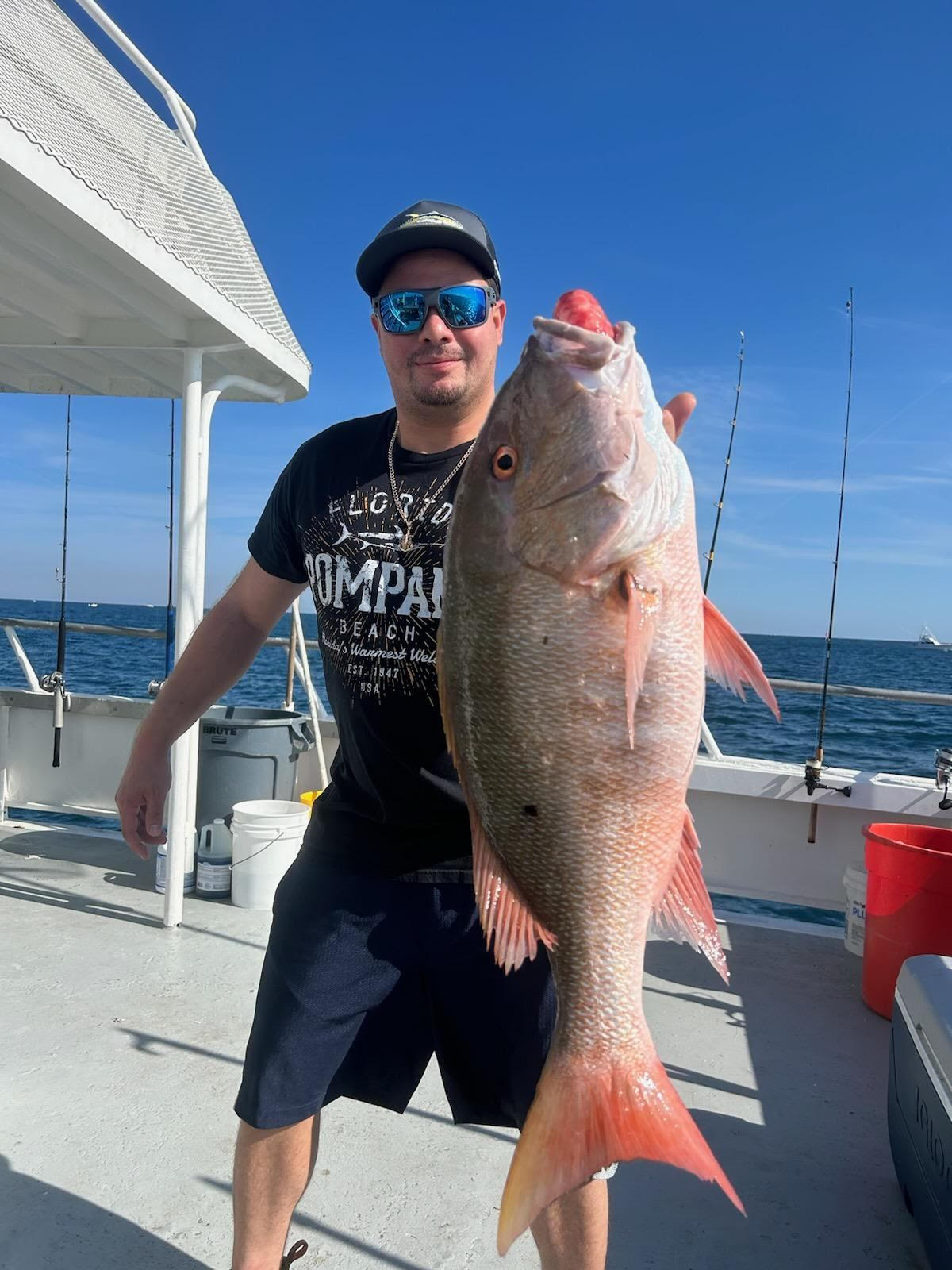 a man holding a fish